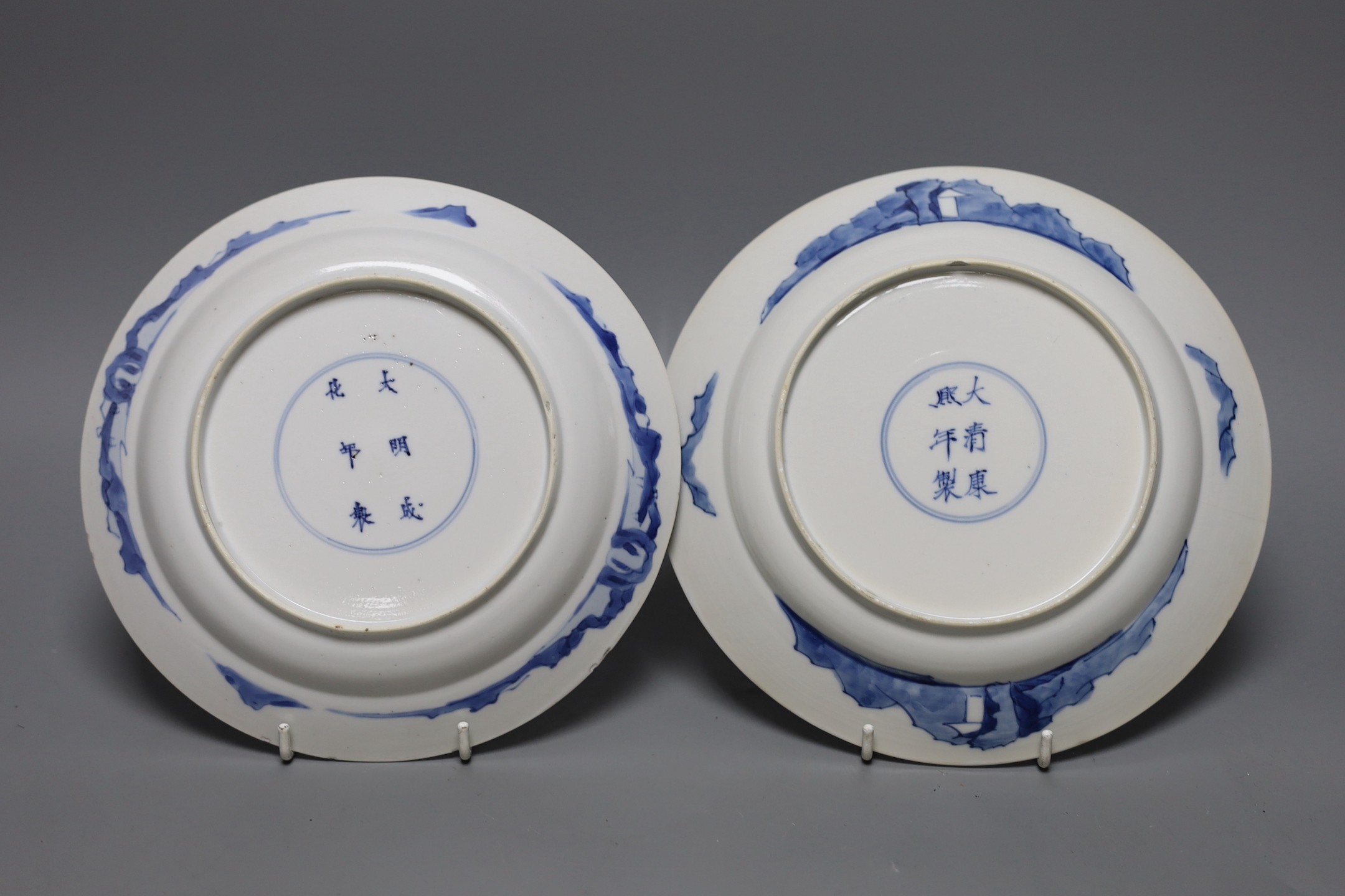 Two Chinese blue and white plates, Kangxi period, one with Kangxi mark the other a Chenghua mark, 21 cms diameter